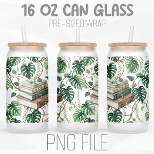 May include: Three 16 oz can glasses with bamboo lids and straws. The glasses are decorated with a watercolor design of green monstera leaves and a stack of books. The text "16 OZ CAN GLASS" and "PRE-SIZED WRAP" is at the top.