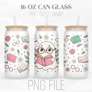 May include: A white 16 oz can glass with a pre-sized wrap featuring a cute ghost reading a book. The wrap has a pink, green, and white floral pattern with glasses and books.