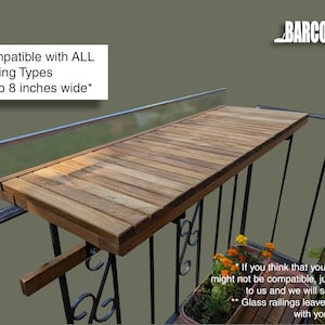Pode incluir: Uma mesa de varanda de madeira, fixada a uma grade de metal preta. A mesa &eacute; feita de t&aacute;buas de madeira marrom claro e foi projetada para caber em grades de at&eacute; 20 cm de largura. O texto "Compatible with ALL Railing Types up to 8 inches wide*" &eacute; vis&iacute;vel.