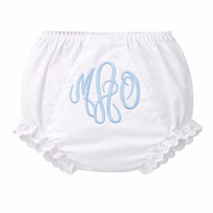 May include: White baby bloomers with a light blue embroidered monogram. The bloomers have a ruffled eyelet lace trim around the legs and an elastic waistband. A classic and elegant design for infants.