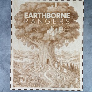 May include: A wooden box with a detailed engraving of a large tree with the text "EARTHBORNE RANGERS". The artwork depicts a fantasy landscape with a path leading to a tree hollow, surrounded by buildings and mountains. The box has a dark brown border.