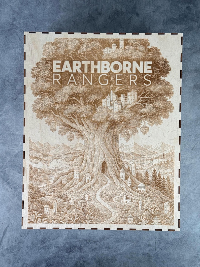 May include: A wooden box with a detailed engraving of a large tree with the text "EARTHBORNE RANGERS". The artwork depicts a fantasy landscape with a path leading to a tree hollow, surrounded by buildings and mountains. The box has a dark brown border.