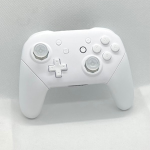 May include: A white Nintendo Switch Pro controller with white button caps. The controller has a standard layout with buttons for A, B, X, Y, and a directional pad.