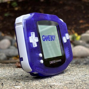 Gaming Bliss Awaits with Retro Gameboy Advance Console Custom Clear Purple Gaming Device - IPS V2 Backlit, 10 Brightness Levels, and USB-C