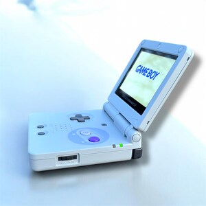 May include: A light blue Game Boy Advance SP handheld game console, open to display the word "GAMEBOY" on the screen. The console features a directional pad, buttons, and a power switch. The screen is approximately 3 inches.