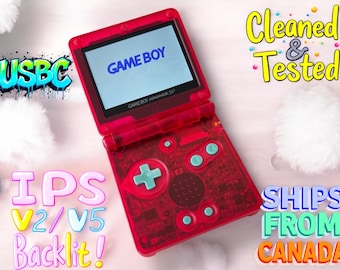 May include: A red Game Boy Advance SP with a clear shell and a blue screen. The screen displays the text "GAME BOY". The buttons are blue and the D-pad is white. The text "Cleaned & Tested" is written in yellow on a white background. The text "IPS V2/V5 Backlit!" is written in colorful letters on a white background. The text "SHIPS FROM CANADA" is written in colorful letters on a white background.