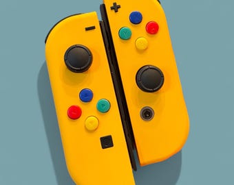May include: A yellow Nintendo Switch controller with colorful buttons. The controller is split into two halves, each with a set of buttons and a joystick.