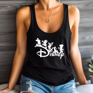 May include: Black vest top with a white Disney logo and cartoon character silhouettes. The top has a scoop neck and is made of a soft material. A gold necklace with a circular pendant is visible.