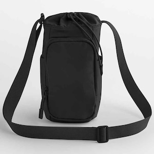 May include: Black water bottle bag with a drawstring closure and a long, adjustable shoulder strap. The bag has a front pocket with a zipper and a side pocket. The bag is made of a durable, water-resistant material.