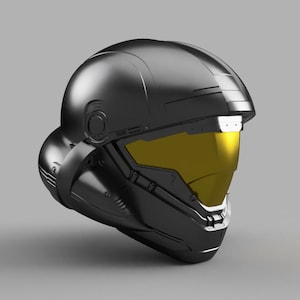 May include: A black helmet with a yellow visor. The helmet has a futuristic design with a lot of detail.