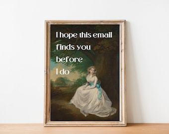 May include: A framed print with a painting of a woman in a white dress sitting in a forest. The text "I hope this email finds you before I do" is printed in white on a dark background.