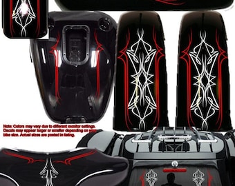 May include: A set of motorcycle pinstripe decals in black, white, and red. The decals are designed to be applied to a motorcycle's gas tank, fenders, and other surfaces. The decals feature a stylized design with a combination of straight and curved lines.