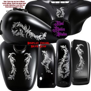 May include: A set of black motorcycle body parts including a fuel tank, fairing, and fenders, decorated with silver leaf filigree decals. The fairing features the text Mad Maiden Studios in purple, and the display color is silver leaf.