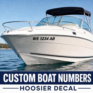 May include: A white motorboat featuring a black bimini top and a metal railing on the bow. The hull displays the black text WS 1234 AB. Below the boat, the text reads CUSTOM BOAT NUMBERS and HOOSIER DECAL in white on a dark blue background.