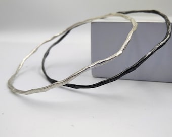 Minimalist silver bangle, hammered in an irregular shape both in sterling and oxidized silver.