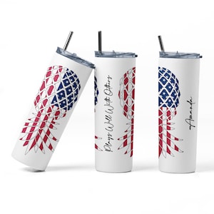 May include: Three stainless steel tumblers with a pineapple design featuring the American flag. The middle tumbler has the text "Plays Well With Others" on it. The tumbler on the right has the name "Amanda" on it.