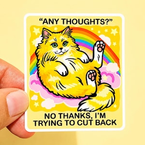 May include: A rectangular sticker featuring a fluffy yellow cat lying on pink clouds with a rainbow background. The text at the top reads "ANY THOUGHTS?" and the text at the bottom reads "NO THANKS, I'M TRYING TO CUT BACK" in bold black letters.