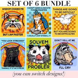 May include: A set of six graphic prints featuring animals and text. Designs include an orange cat with a rainbow, a wizard cat reading, a goose, a black cat in flames, an opossum, and a raccoon. Text includes Wisdom chases me but I am faster, I don't need a recipe for disaster I usually just eyeball it, Things are going to be difficult but you are going to be difficulter, You look stressed thanks it's the stress, Solvem Probler, and Don't yell at me I'll cry.