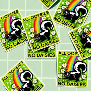 May include: A rectangular sticker featuring a black and white skunk standing in a green field with white daisies and a rainbow. The text ALL OOPSIES NO DAISIES is printed in black capital letters at the top and bottom of the sticker design.
