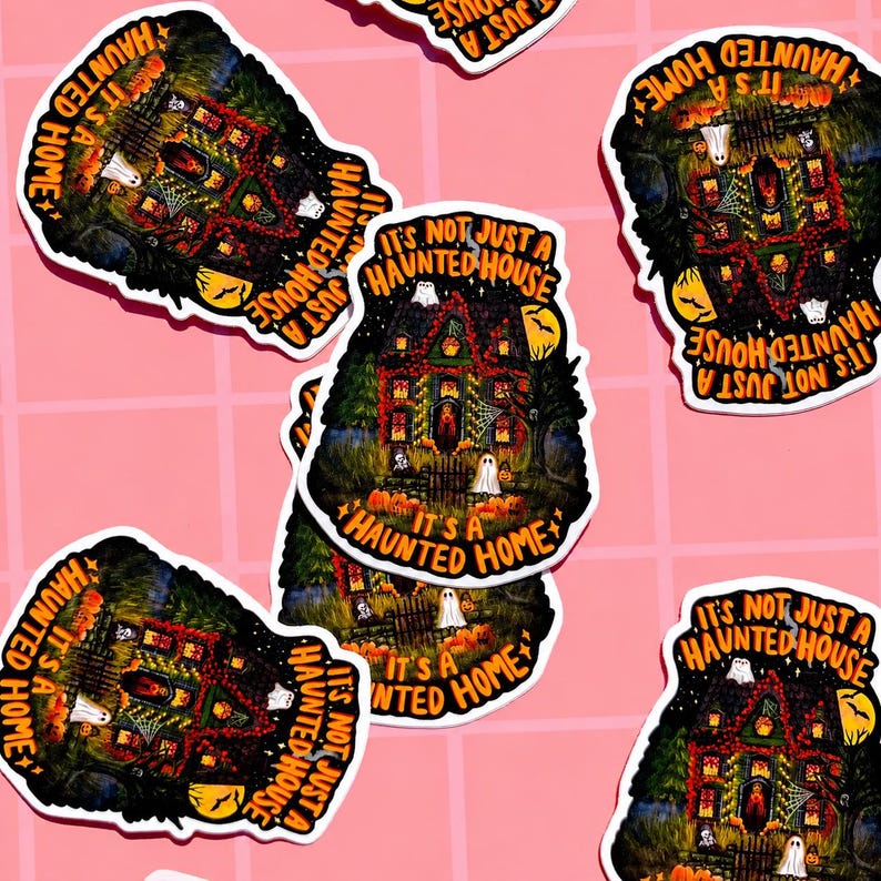 May include: A collection of Halloween-themed stickers featuring a spooky haunted house design. The stickers have a black background with a detailed illustration of a haunted house, ghosts, pumpkins, and the text "It's Not Just A Haunted House, It's A Haunted Home."