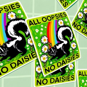 May include: A rectangular sticker featuring a black and white skunk on a bright green background with white daisies, a colourful rainbow, and the black text ALL OOPSIES NO DAISIES. The design includes several daisy flowers with small smiling faces.