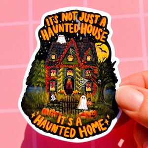 May include: A Halloween-themed sticker featuring a spooky haunted house illustration. The house is decorated with lights, pumpkins, and ghosts, with the text "It's Not Just a Haunted House, It's a Haunted Home."