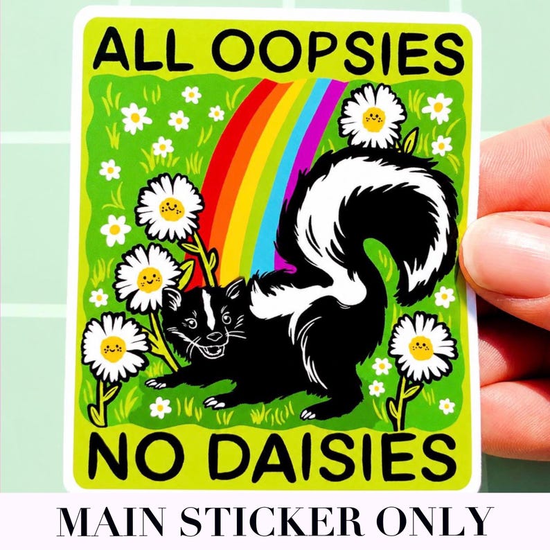 May include: A rectangular sticker featuring a black and white skunk standing in a green field with white daisies that have smiling faces. A colourful rainbow arches behind the skunk. The text ALL OOPSIES NO DAISIES is printed in black capital letters.