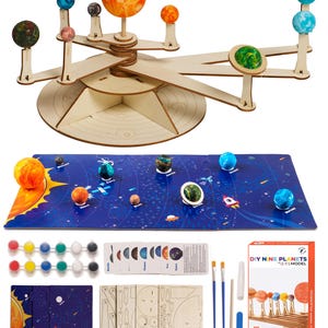 May include: A wooden DIY solar system model kit with nine planets, paint, brushes, and a guide. The planets are painted in various colors, including blue, green, red, and orange. The kit includes a wooden base with a rotating arm for the planets. The box says "DIY Nine Planets Solar System Model".