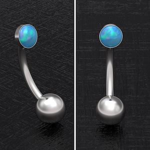 May include: A silver belly button ring with a blue opal gemstone and a silver ball on the bottom.