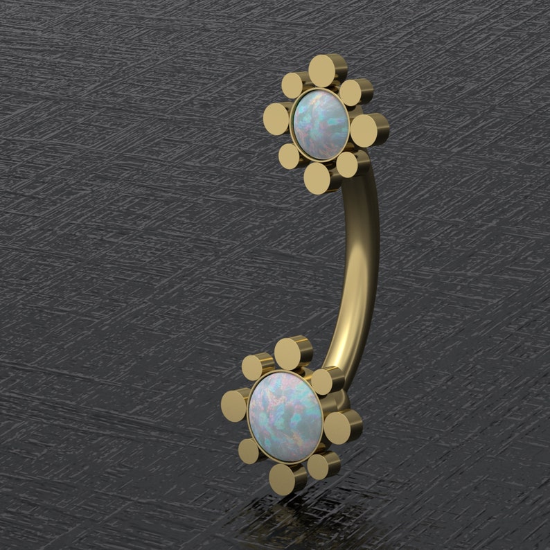 May include: Gold body jewelry with a curved barbell and two opal flower-shaped ends. Each flower has a center opal surrounded by a circle of smaller gold beads.