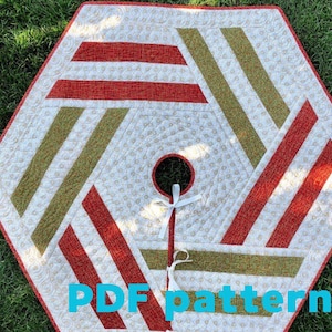May include: Hexagon-shaped Christmas tree skirt with red and green stripes on a white background. The skirt has a center hole with a red border and a white ribbon tie. The text "PDF pattern" is visible.
