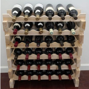 May include: A wooden wine rack with five shelves, each holding six bottles of wine. The rack is made of natural wood and has a rustic look. The bottles are all different colors and have labels on them.