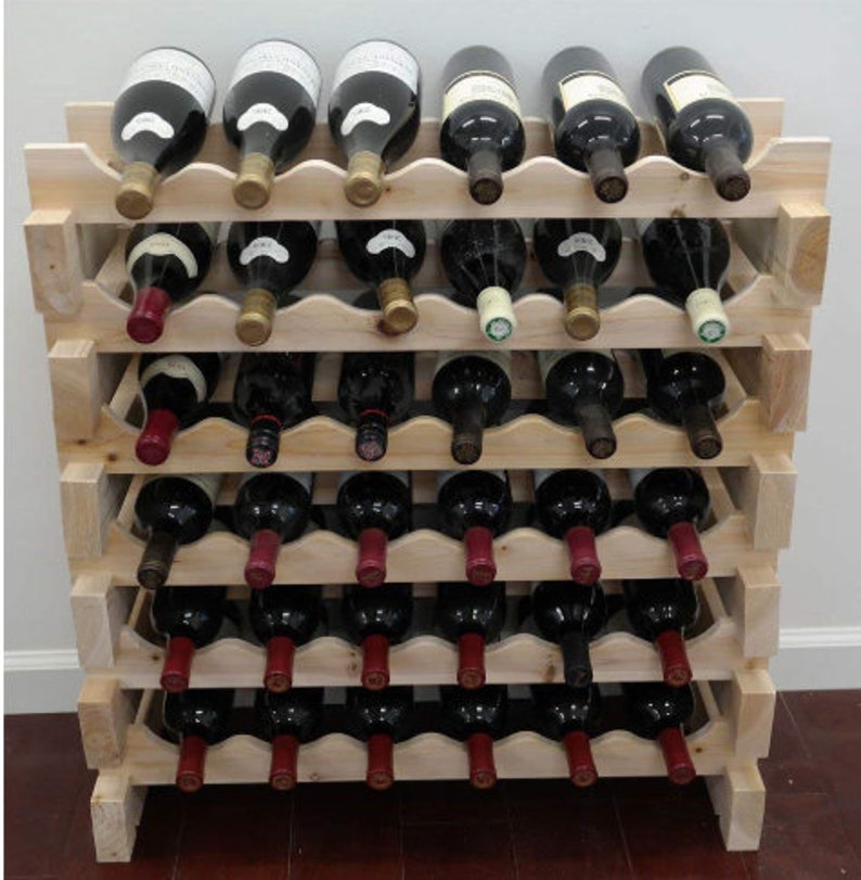 May include: A wooden wine rack with five shelves, each holding six bottles of wine. The rack is made of natural wood and has a rustic look. The bottles are all different colors and have labels on them.