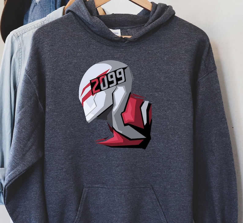 May include: Dark gray hoodie with a graphic of a futuristic helmet design. The helmet is white, gray, and red, with the number "2099" printed on the front. The hoodie has a drawstring hood and a front pocket.