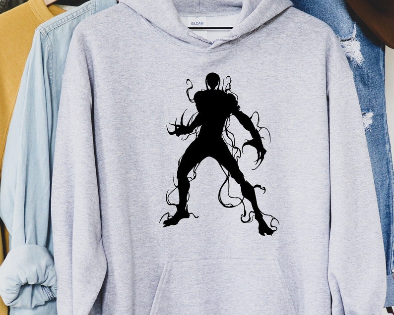 May include: A light gray hoodie featuring a black silhouette of a creature with sharp claws and tendrils. The graphic is centered on the front of the hooded sweatshirt. The hoodie has a drawstring and a front pocket.