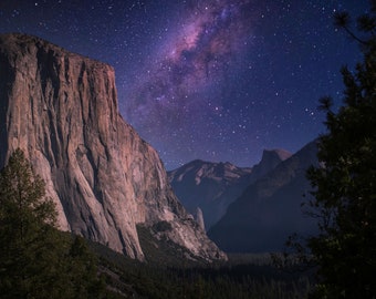 May include: A night sky filled with stars and the Milky Way galaxy over a mountain range. The mountain range is silhouetted against the dark sky.