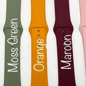May include: Eight different colored silicone Apple Watch bands. The colors are lilac, midnight blue, moss green, orange, maroon, dusty rose, pale turquoise.