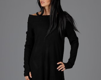 May include: Black off-the-shoulder sweater dress with long sleeves and a high-low hemline.