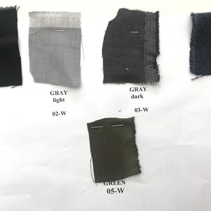 May include: Fabric swatches in black, light gray, dark gray, blue, and green. The swatches are labeled with the color and a number.
