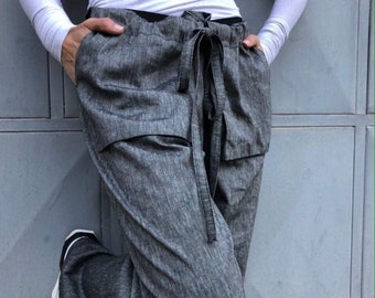 Pantalones de lino italiano: Pantalones negros de corte relajado con bolsillos 3D.