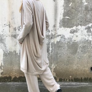Handgemaakte gebreide loungeset: asymmetrisch vest van wolmix en broek met wijde pijpen