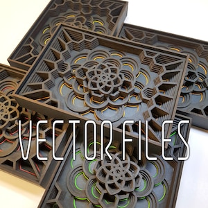 Op de afbeelding: Drie gelaagde houten frames met ingewikkelde geometrische ontwerpen. De frames zijn zwart met oranje, gele en groene accenten. De tekst "VECTOR FILES" is zichtbaar in het midden van de afbeelding.