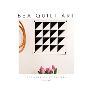 May include: A square quilt with a black and white geometric pattern hangs on a wall. The quilt features alternating black triangles. The text "BEA QUILT ART" is at the top, with "BEGINNER QUILT PATTERN" and "QUILT ART" at the bottom.