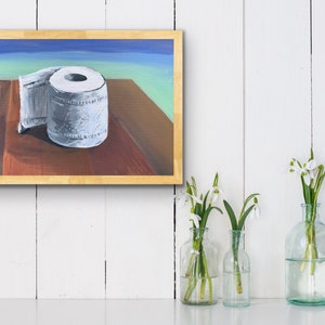May include: A painting of a white toilet paper roll on a wooden table with a blue and green background.