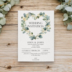 May include: Wedding invitation with a green and gold eucalyptus wreath in the shape of a heart. The text reads "Wedding Invitation", "Eden & James", "request the pleasure of your company at their wedding at St Peter's Church", "Saturday 08.06.24 1.30PM", "followed by a wedding breakfast and evening reception at The Manor Hotel", "RSVP 01234567890".