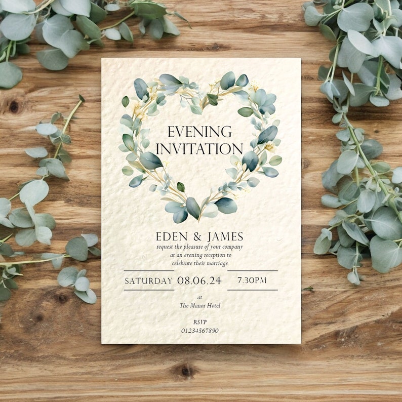 May include: A wedding invitation with a heart-shaped wreath of eucalyptus leaves and gold accents. The text reads "Evening Invitation" and includes the names Eden & James, the date Saturday 08.06.24, the time 7:30PM, the location The Manor Hotel, and the RSVP information 01234567890.