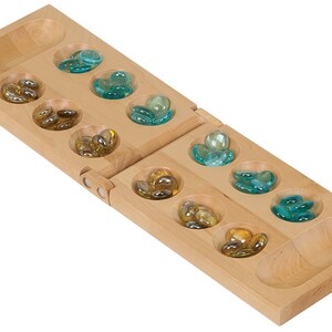 May include: A wooden Mancala board game with two rows of six pits, each containing glass marbles. The pits are filled with blue and yellow marbles.
