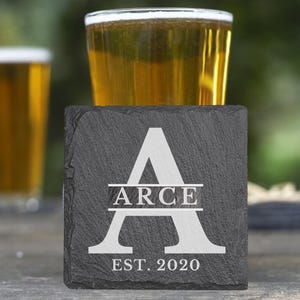 May include: Black slate coaster with a white letter A and the text "ARCE EST. 2020".