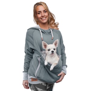 May include: A gray hoodie with a built-in pocket for a small dog. The hoodie has a drawstring hood and a zippered pocket on the front. The word "rodica" is printed on the front of the hoodie.