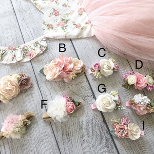 May include: Nine floral hair accessories with different styles and colors. The accessories are arranged on a light wood surface. The accessories are labeled with letters A through I.
